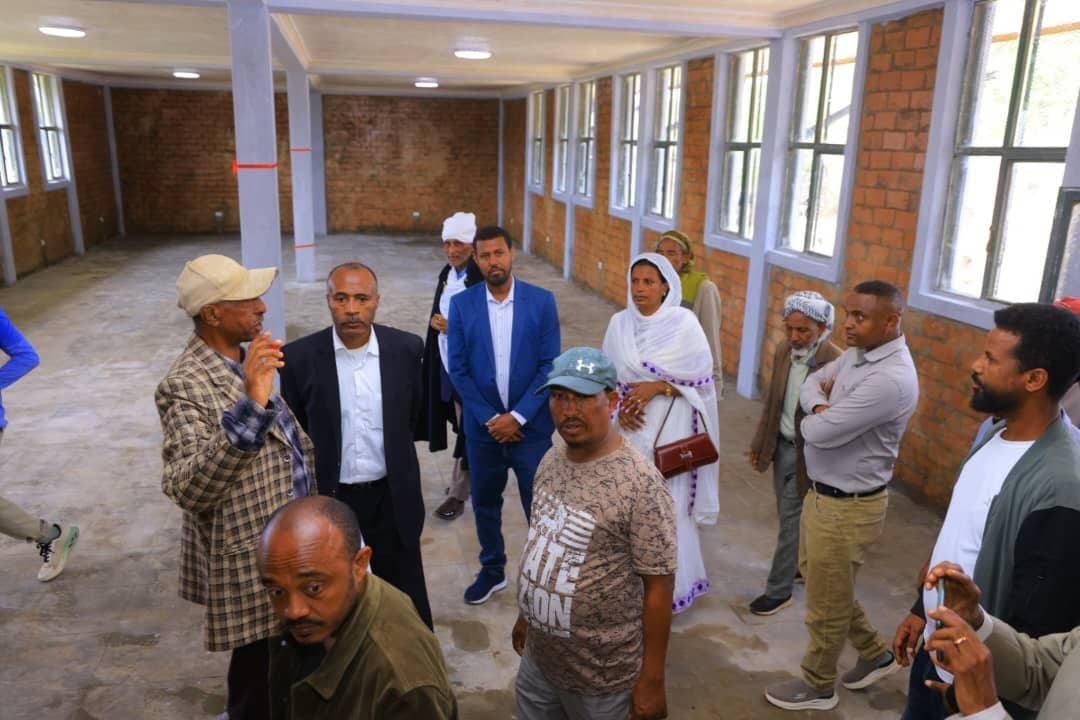 Erkab leaders and community elders touring the interior of the newly built training center hall in Gondar